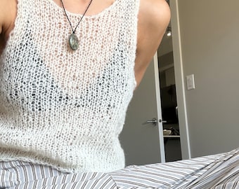 Hand-knit, cream coloured tank with open sides made with a blend of wool and cotton yarn