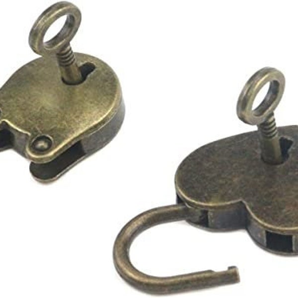 May include: Two antique-style padlocks with keys. One is heart-shaped, the other is oval. Both are open, showing the curved shackle. The metal has a tarnished, bronze finish, suggesting an aged appearance.