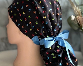 Ponytail scrub caps/Paw prints on Black Ponytail Scrub Cap for Women/Surgical caps/Scrub Hats with Aqua blue Grosgrain Ribbons.