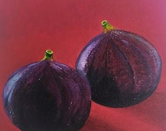 May include: Two dark purple figs on a red background. The figs have a slightly textured surface and are in focus.