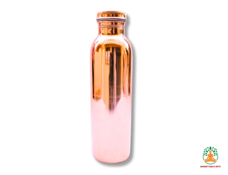 May include: A copper water bottle with a shiny, reflective surface. The bottle has a rounded base and a screw-on cap. The copper color transitions from a warm orange to a soft pink near the bottom. The bottle is designed for hydration.