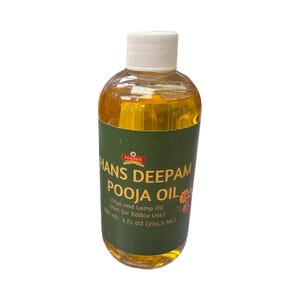May include: A clear glass bottle with a white cap filled with yellow liquid. The label is green with white text that reads "HANS DEEPAM POOJA OIL Diya and Lamp Oil (Not for Edible Use) NET WT - 8 FL OZ (236.5 ML)"