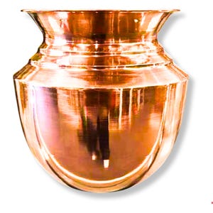 May include: A copper-colored, handcrafted pot with a wide, flared rim and a bulbous body. The pot has a polished, reflective surface, and the design features several horizontal bands. The pot is likely used for decorative or ceremonial purposes.