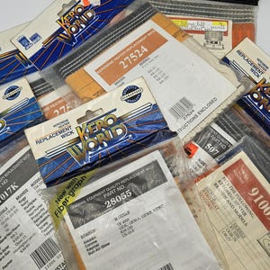 May include: Assortment of Kero World kerosene heater replacement wicks in various packaging. The packages feature different part numbers, model numbers, and brand names. The wicks are white and made of a fibrous material.