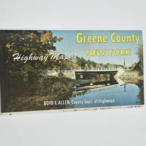 May include: Vintage Greene County, New York highway map. The cover features a scenic bridge over a river, with the text "Greene County NEW YORK" in yellow. The map also includes the text "Highway Map of" and "BOYD F. ALLEN, County Supt. of Highways."
