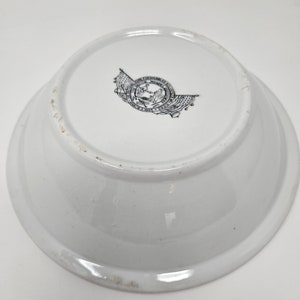 May include: White ceramic bowl with a black and white logo on the bottom. The logo features two flags and the text "Union for American Progress, Founded 1865".