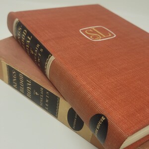 May include: Two hardback books stacked on top of each other. The top book is red with gold lettering and a gold seal with the letters "SL". The bottom book is brown with black lettering and the words "Random House" printed on the spine.