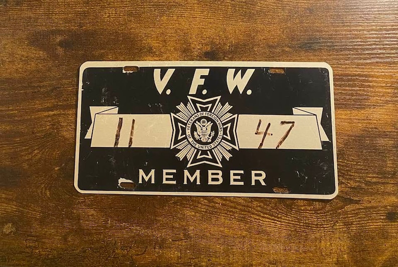 May include: Black and white V.F.W. membership card with a gold star and the text "Veterans of Foreign Wars of the United States" and the numbers "11 47".