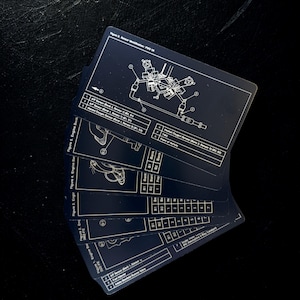 May include: A fan of dark blue cards with white technical diagrams and text. The cards display engine schematics and component details. The cards are arranged in a fanned-out pattern against a black background.