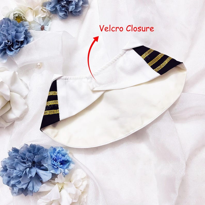 May include: White sailor hat with black and gold stripes. The hat features a Velcro closure. The hat is white with a black and gold striped design on the sides. The hat is a nautical themed accessory.