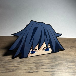 May include: A blue and black anime character sticker with blue eyes peeking out from behind a wooden surface.