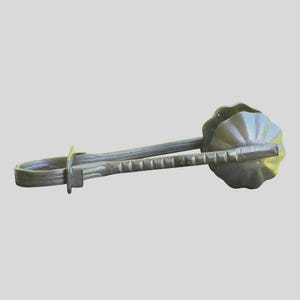 May include: A metallic kitchen tool featuring a long, slender handle with a series of small, evenly spaced indentations along its length. The tool terminates in a rounded, fluted, or scalloped cup-shaped end, resembling a small mold or press.
