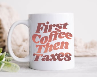 May include: White ceramic coffee mug with a pink and orange gradient design. The mug has the text "First Coffee Then Taxes" printed on it.