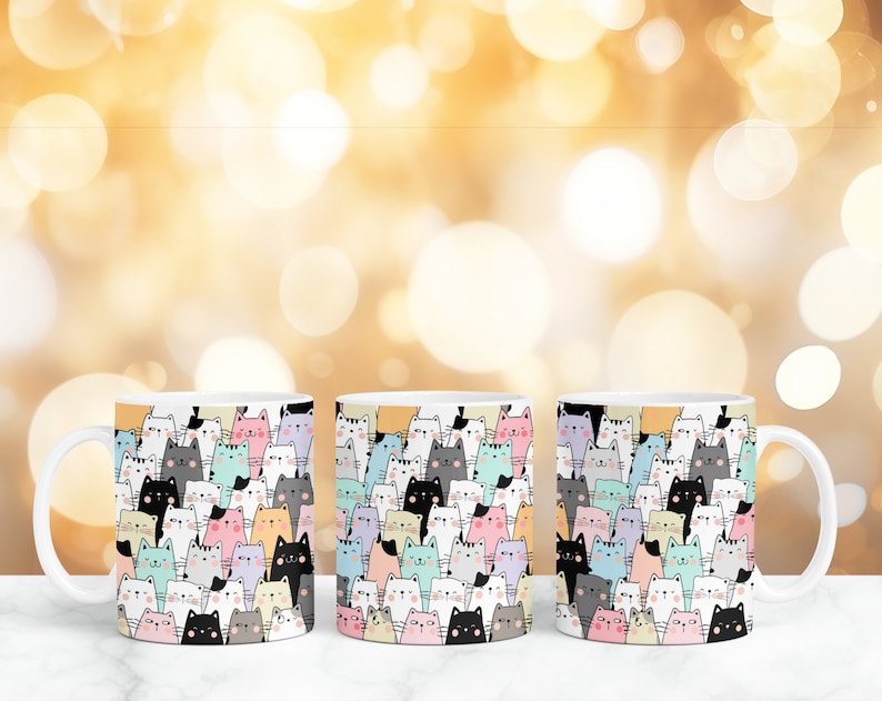 May include: Three white ceramic mugs with a colorful pattern of cartoon cats. The cats are in various colors, including pink, blue, yellow, and gray.