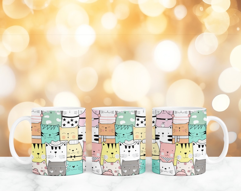 May include: Three white ceramic mugs with a colorful pattern of cartoon cats. The cats are wearing hats and have different expressions.