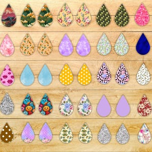 May include: A collection of 60 earring designs featuring various patterns and colors. The earrings are made of different materials, including metal, plastic, and fabric. The designs include floral patterns, geometric shapes, abstract designs, and more.