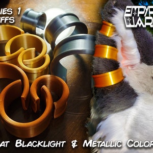 May include: Series 1 Cuffs in blacklight and metallic colours. The cuffs are made of plastic and come in a variety of sizes. The cuffs are shown on a furry, grey and white, animal costume.