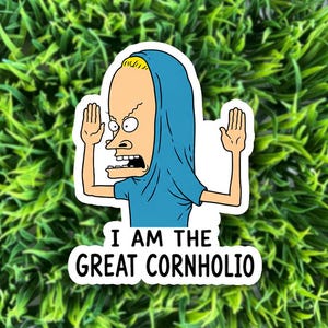 May include: A die-cut sticker featuring a cartoon character with blonde hair, wearing a blue shirt pulled over their head like a hood, with arms raised. Below the character, black text reads: I AM THE GREAT CORNHOLIO, set against a white background.