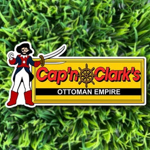 May include: A rectangular sticker featuring a cartoon pirate with a hook and sword standing next to a yellow sign. The sign displays the red text Cap'n Clark's with a brown ship wheel and the black text OTTOMAN EMPIRE on a white background.