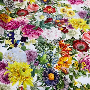 May include: A white fabric with a floral print featuring a variety of colorful flowers, including pink peonies, yellow sunflowers, purple asters, and white daisies.