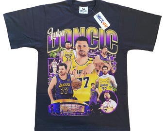 May include: Black t-shirt featuring a collage of images of Luka Dončić in Lakers jerseys. The design includes the name "Luka Dončić" in a stylized font, with the number 77 prominently displayed. A "KICKART" tag is attached.