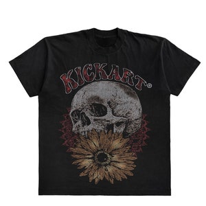 May include: Black t-shirt with a graphic print of a skull with a sunflower. The text "KICKART" is printed above the skull.