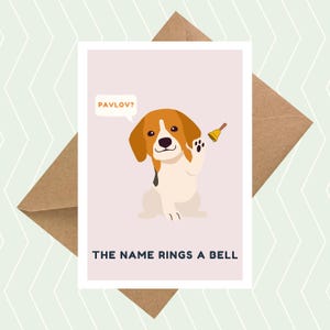 May include: A greeting card featuring a cartoon beagle dog holding a bell. The card has the text "Pavlov?" in a speech bubble above the dog and "The name rings a bell" below the dog.