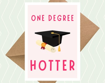May include: A pink card with the text "ONE DEGREE HOTTER" in pink letters. A black graduation cap with a gold tassel sits on top of a rolled up diploma with a gold seal.