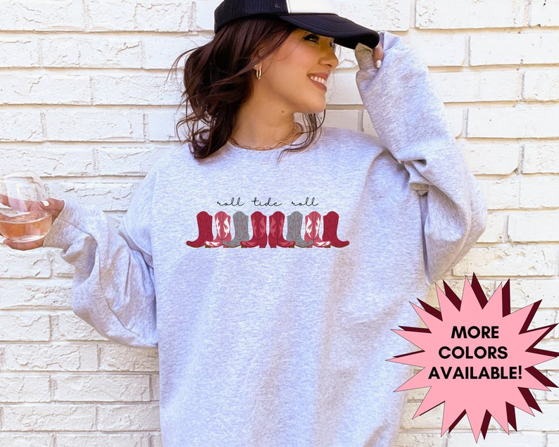 May include: Gray sweatshirt with the text "roll tide roll" and a graphic of red and gray cowboy boots.