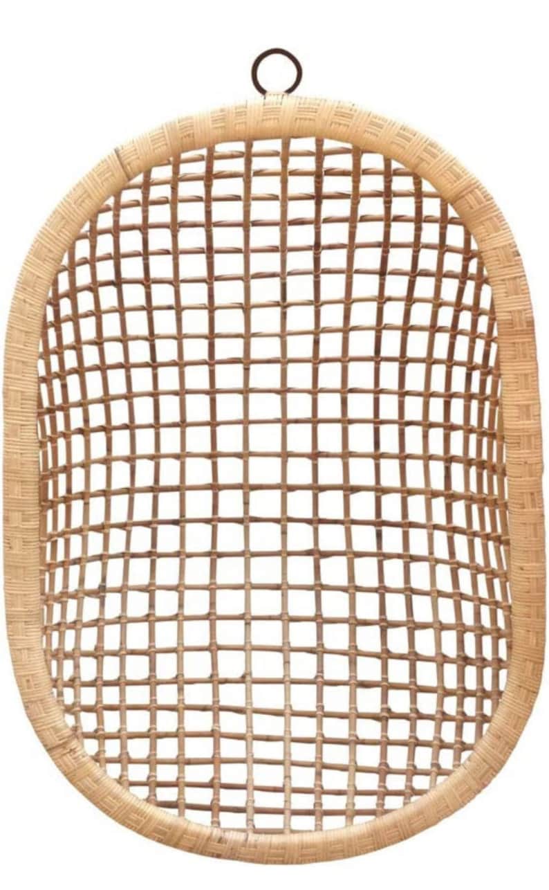 May include: A natural woven rattan hanging chair with a round metal ring at the top.