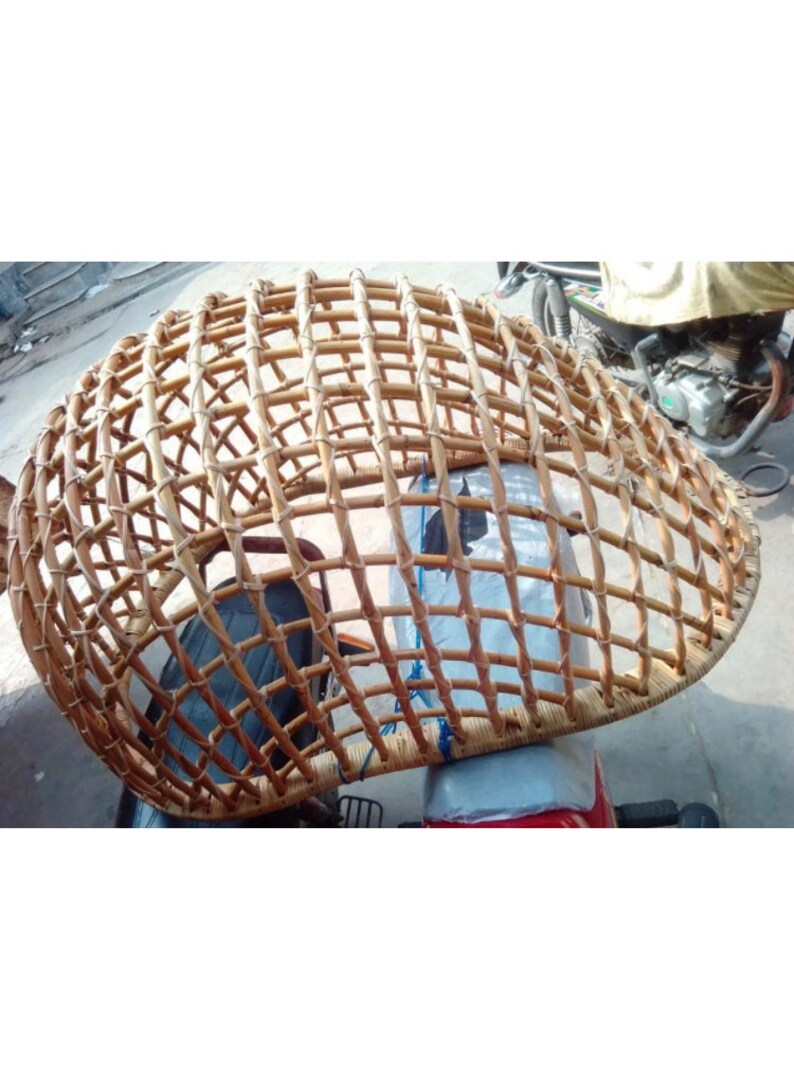May include: A woven wicker dome-shaped structure, possibly a protective cover for a motorcycle.
