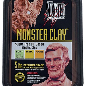 May include: A black tray of Monster Clay, a sulfur-free oil-based elastic clay. The label features a monster head and a bust of a man. The clay is labeled as soft, medium, or hard, and weighs 2.27 kilograms.