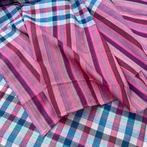 May include: A set of three ceramic mugs with a speckled, matte finish. Each mug features a different color: light blue, cream, and gray. The mugs have a simple, modern design, perfect for coffee or tea.