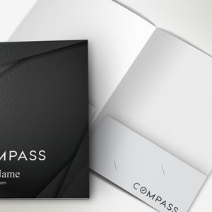 May include: A black and white business folder with the word "COMPASS" and the text "Your Name" and "your websites.com". The folder is open, revealing a blank white interior.