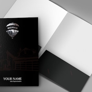 May include: Black real estate folder with a silver hot air balloon logo that says "RE/MAX" and a black and white illustration of a house. The text "YOUR NAME" and "Sales Representative" is printed below the illustration.