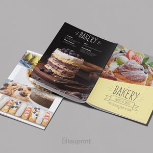 May include: A bakery menu with images of cakes and pastries. The open pages display a layered cake with blueberries, a pastry with fruit, and various other baked goods. The menu has the word "Bakery" on it.
