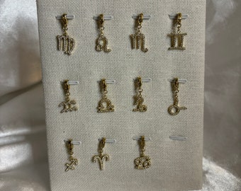 Golden astrological sign charms with rhinestones
