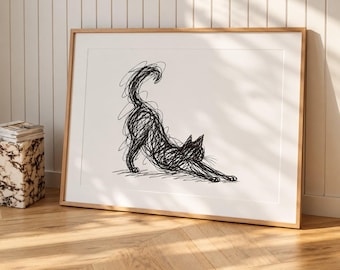 May include: A framed wall art print featuring a black ink scribble drawing of a cat in a stretching pose. The cat is rendered with chaotic, overlapping lines on a plain white background, enclosed within a light-toned wooden frame.
