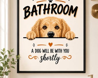 May include: Framed wall art with a black border. The artwork features a Golden Retriever dog peeking over a line. Text reads "WELCOME TO THE BATHROOM" and "A DOG WILL BE WITH YOU shortly".