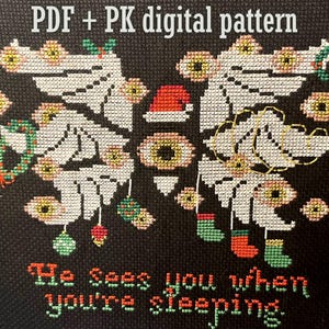 May include: Cross-stitch design on black fabric with the text "He Sees you when you're sleeping." The pattern includes white wings, eyeballs, a Santa hat, Christmas ornaments, and stockings. The words "PDF + PK digital pattern" are at the top.