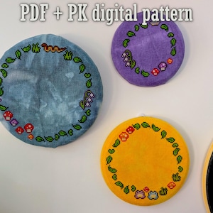 May include: Three circular cross-stitch patterns with floral and insect designs. The patterns are in blue, purple, and yellow, with green leaves and colourful accents. The text "PDF + PK digital pattern" is at the top.