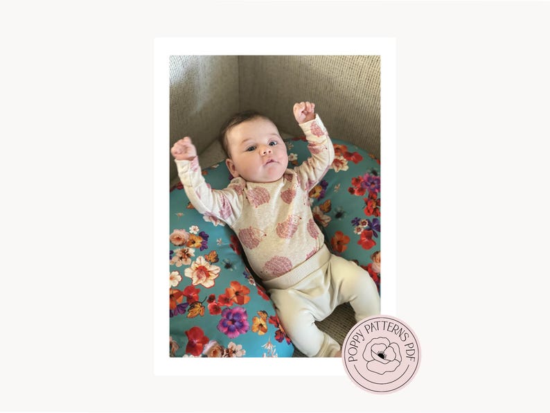 An image of the handmade nursing pillow cover with being used by a baby with their arms raised in the air. PoppyPatternsPDF Logo is featured in the bottom right corner.