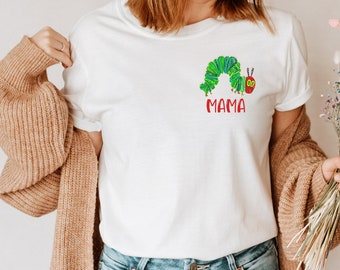 May include: White t-shirt with a green caterpillar graphic and the word "MAMA" in red letters.