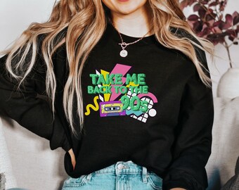 May include: Black sweatshirt with a graphic print of a cassette tape and the text "Take Me Back to the 90s" in colorful, geometric shapes.