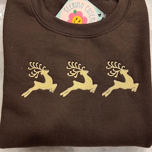 Felpa ricamata con renne natalizie