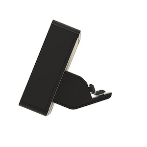 May include: A black angled stand with a rectangular top and a supporting base. The stand has a minimalist design and appears to be made of a solid material. The base has a small, adjustable component.