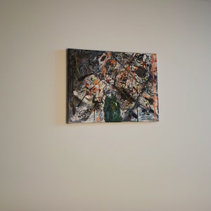 May include: Abstract painting with a mix of black, white, orange, and green paint splatters and brushstrokes on a canvas.