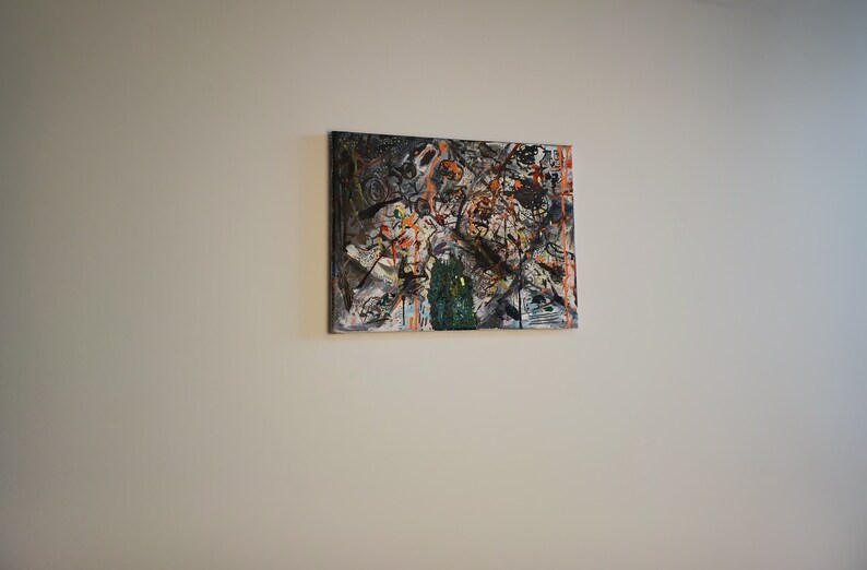 May include: Abstract painting with a mix of black, white, orange, and green paint splatters and brushstrokes on a canvas.
