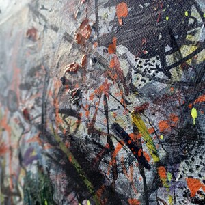 May include: Abstract painting on canvas with a textured surface. The painting features a variety of colors, including black, white, orange, yellow, and green. The paint is applied in a variety of ways, including splatters, drips, and brushstrokes.