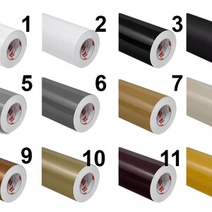 Puede incluir: Doce rollos de vinilo adhesivo dispuestos en una cuadr&iacute;cula, numerados del uno al doce. Los colores incluyen blanco, negro, varios tonos de gris, beige, bronceado, marr&oacute;n, marr&oacute;n oscuro y amarillo, cada uno con un n&uacute;cleo de cart&oacute;n blanco.